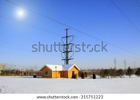 Cabin and electric steel rod in the snow, closeup of photo