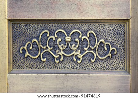 enchased in metal decorative pattern on the stone wall