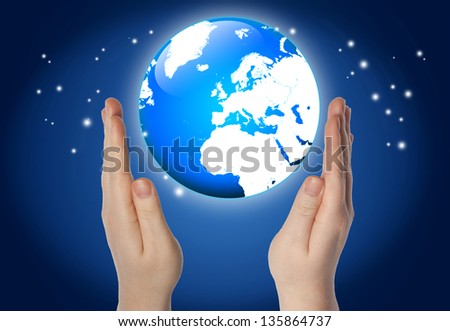 world or globe in your hands on blue background