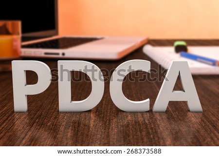 PDCA - Plan Do Check Act - letters on wooden desk with laptop computer and a notebook. 3d render illustration.