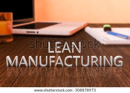 Lean Manufacturing - letters on wooden desk with laptop computer and a notebook. 3d render illustration.