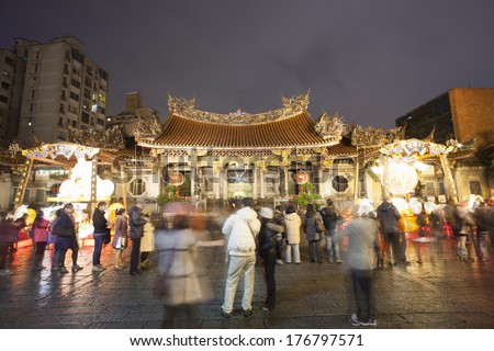 TAIPEI, TAIWAN - FEB 9: Worshipers and visitors visiting Longshan Temple during the lantern Festival season on February 9, 2014 in Taipei, Taiwan.
