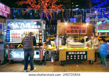 TAIPEI - TAIWAN, December 5th, 2014: People by the stands at Raohe Street Night Market in Taipei on December 5th. Raohe Night Market is one of the biggest, oldest, and popular in Taipei