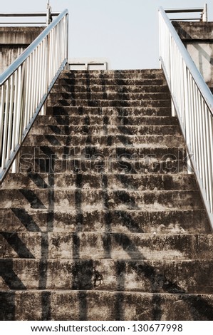 Old concrete stairway of the overpass in the city.