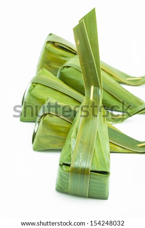 Thailand dessert wrapped in banana leaves ,coconut milk custard with coconut sweet ,word in Thai 
