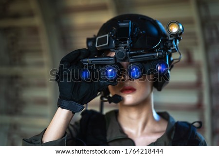 Portrait of female modern army special forces soldier, anti terrorist squad fighter, elite commando warrior using four-eyed night vision goggles in dark background Stock foto © 