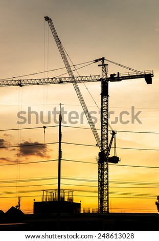 Silhouette of construction site in sunset.