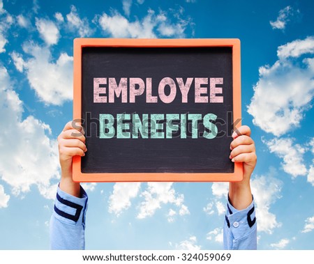 Employee Benefits word on blackboard with hands are holding.