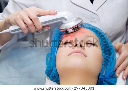 Portrait  girl cosmetic procedure portable  light therapy