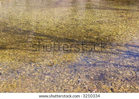 Yellow stone background shot from directly above the water surface.