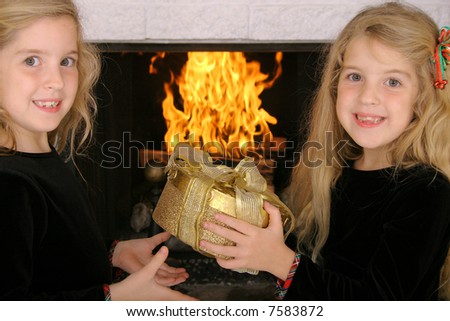 twin sister gift exchange by fireplace