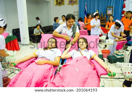 SINGBURI - JUNE 12 : Unidentified blood donors in World Blood Day 2014 at Sing Buri Red Cross office on June 12, 2014 in Singburi, Thailand.