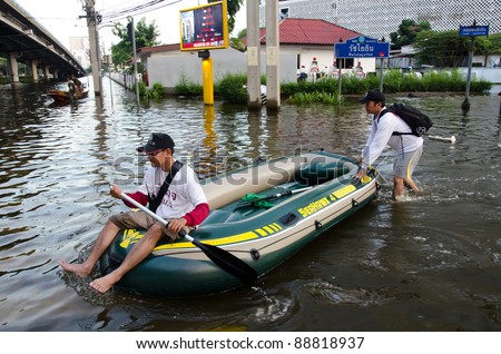 BANGKOK THAILAND – NOVEMBER 13: Thai police acts as a water police during the massive flood crisis on November 13, 2011 in Bangkok, Thailand.