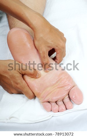 reflexology foot massage with oil isolated white background