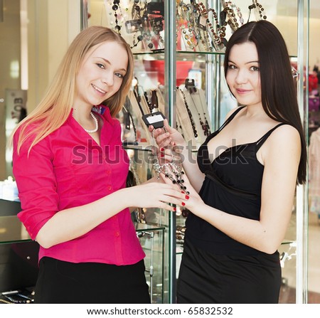 girls in a shop trying beautiful decoration on