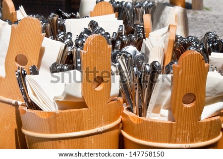 forks, spoons and knives prepared to be served in an outdoor cafe