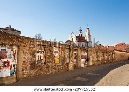 Vilnius, Lithuania - March 17, 2015: Brick wall with posters in the old town of Vilnius.