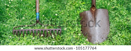 Metal Garden Rake and Shovel on top of Lawn