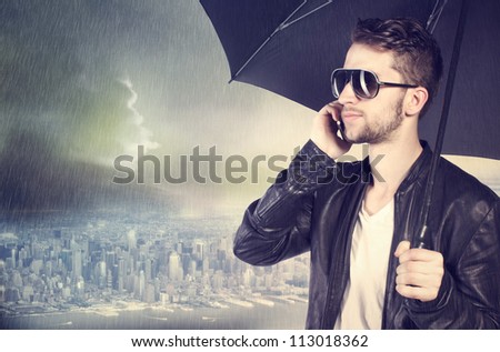 Stylish man talking on his cellphone in the rain