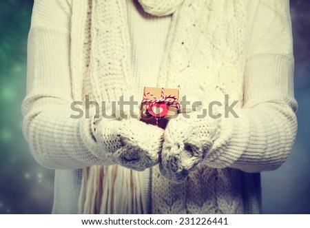 Small gift box in womans hands with white gloves