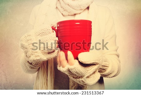 Woman holding a red mug in vintage style
