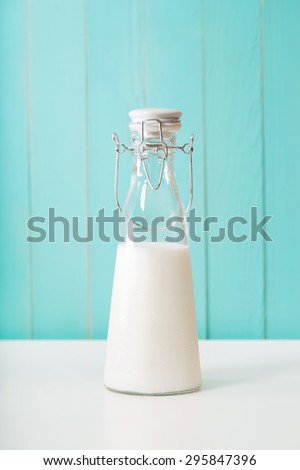 Old fashioned milk jar on pastel blue background