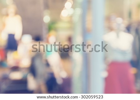 Defocused clothing store front entrance displaying woman\'s fashion