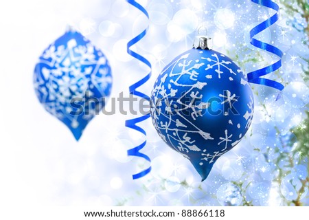 Christmas blue ornaments over abstract lights background