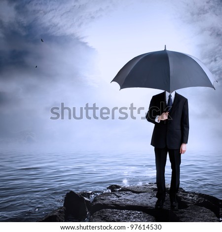 Business Man Holding Umbrella at the Coast After or Before a Storm