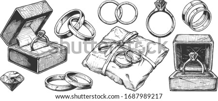 Vector hand drawn illustration of different wedding jewelry rings in vintage engraved style. isolated on white background.