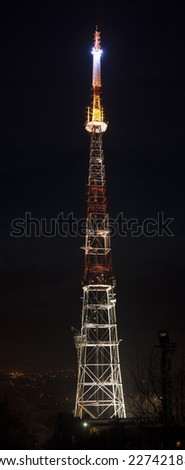 photo of shining communications TV tower at night.