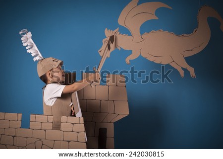 photo of the boy in medieval knight costume made of cardboards