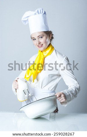 Photo of a young cook working with mixer