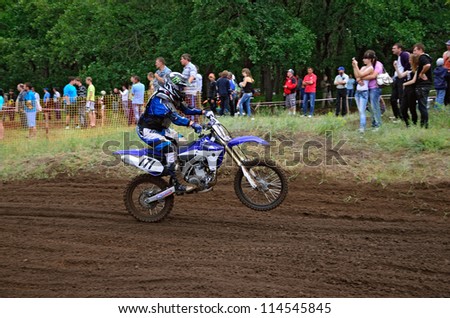 RUSSIA, SAMARA - JUNE 16: Racer A. Belov on a motorcycle rides on a the rear wheel the Regional Motocross Championship on June 16, 2012 in Samara, Russia
