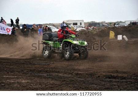RUSSIA, SAMARA - MAY 6: ATV cross O. Orlov rider in the movement as the crow flies, against the background of the audience, the ATV class the Regional Motocross on May 6, 2012 in Samara, Russia