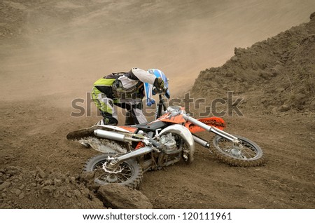 RUSSIA, SAMARA - MAY 6: Crash motocross rider N. Kornev with a fall on the dusty track, the 65 sm3 class the Regional Motocross Championship on May 6, 2012 in Samara, Russia