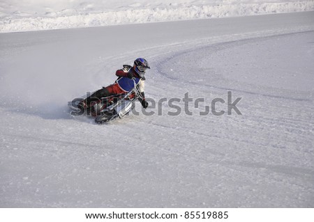 SAMARA, RUSSIA - FEBRUARY 19:  Motorbike with spikes unidentified the driver turns the large slope on knee, Speedway on the ice Championship on February 19, 2011 in Samara, Russia