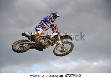 RUSSIA, SAMARA, CHAPAYEVSK - OCTOBER 17: Spectacular jump motocross racer A. Nikishkin on the background a stormy sky the Open Cup \
