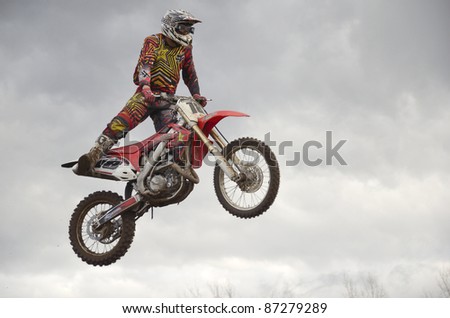 RUSSIA, SAMARA, CHAPAYEVSK - OCTOBER 17: The spectacular jump motocross racer unknown on the background a stormy sky the Open Cup \