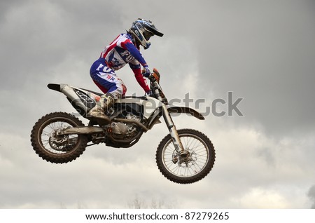 RUSSIA, SAMARA, CHAPAYEVSK - OCTOBER 17: The spectacular jump motocross racer A. Nikishkin on the background a sky the Open Cup \