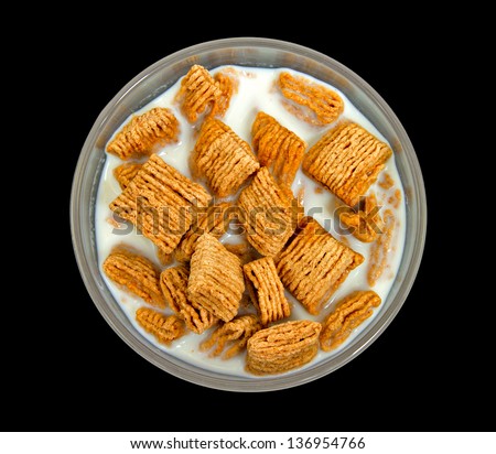 Bowl of Healthy Wheat Squares Cereal with Milk from Top View with Black Background