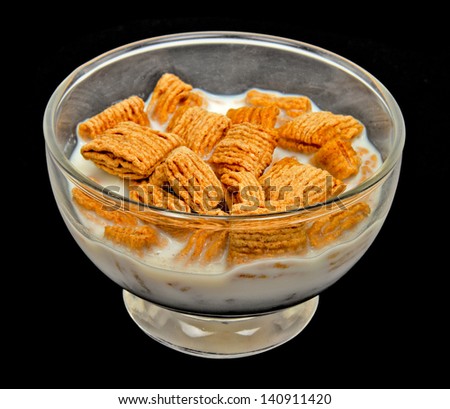 Bowl of  Wheat Squares Cereal and Milk with Black Background