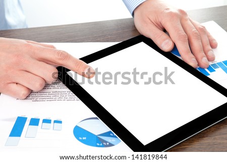 businessman holding a tablet computer with isolated screen on the table with graphics