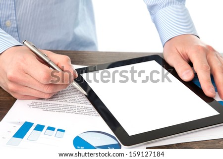 businessman holding a tablet computer with isolated screen on the table with graphics