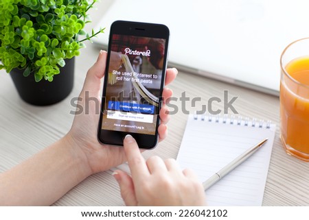 Alushta, Russia - October 24, 2014: Girl holding a iPhone 6 Space Gray with social Internet service Pinterest on the screen. iPhone 6 was created and developed by the Apple inc.
