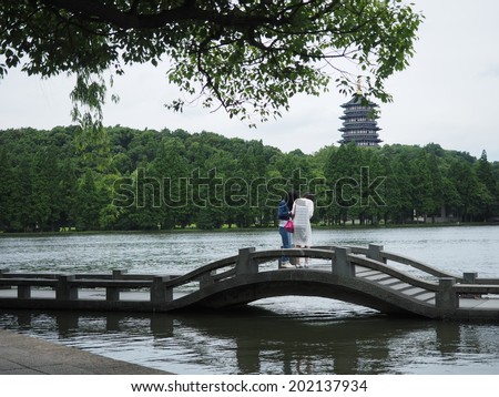 HANGZHOU, CHINA - MAY 23: Visitors visit the infamous West Lake on May 23, 2014 in Hangzhou, China. It was made a UNESCO World Heritage Site in 2011.