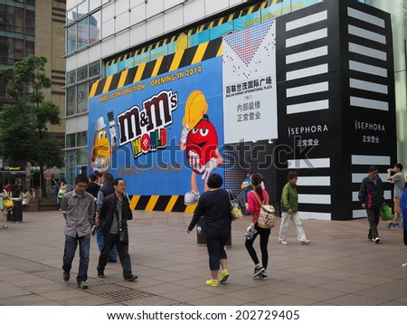 SHANGHAI,CHINA - MAY 18: Tourists at the famous shopping street, Nanjing road, in Shanghai, China on May 18, 2014. Nanjing Road is one of the world\'s busiest and longest shopping district.