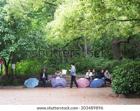 SHANGHAI, CHINA - MAY 18: People posted their unmarried children\'s advertisement and photos, boasting their education, salary levels in People\'s Park on May 18, 2014 in Shanghai,China.
