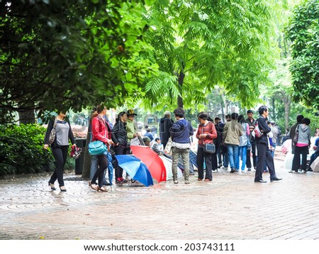 SHANGHAI, CHINA - MAY 18: People post their unmarried children\'s advertisement and photos, boasting their education, salary levels in People\'s Park on May 18, 2014 in Shanghai,China.