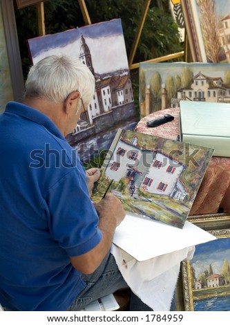 A man painting a picture with oil paint